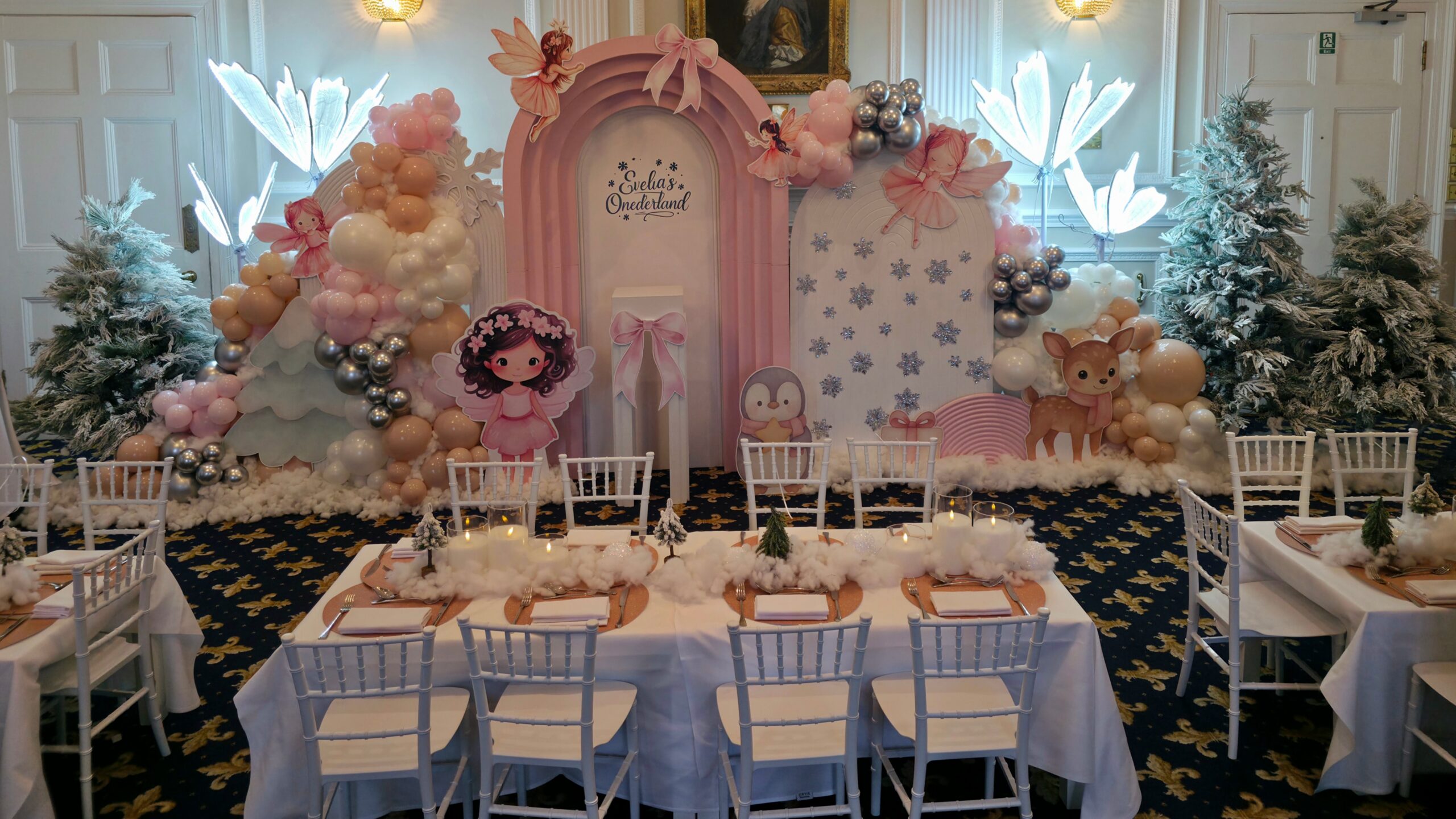 Luxury winter wonderland party styling with kids seating, themed backdrop and table decor at West Lodge Park Hotel