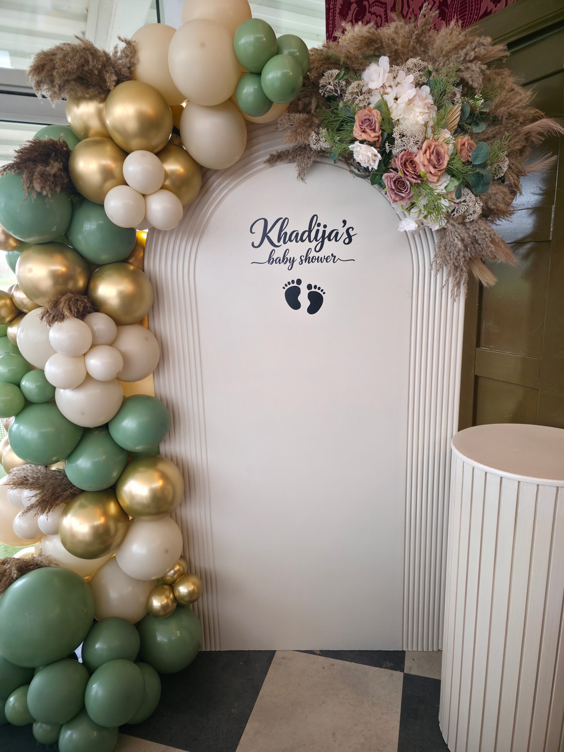 Personalised baby shower backdrop for Khadija at The Orangery by Sapna featuring sage green, gold and ivory balloon decor with floral styling