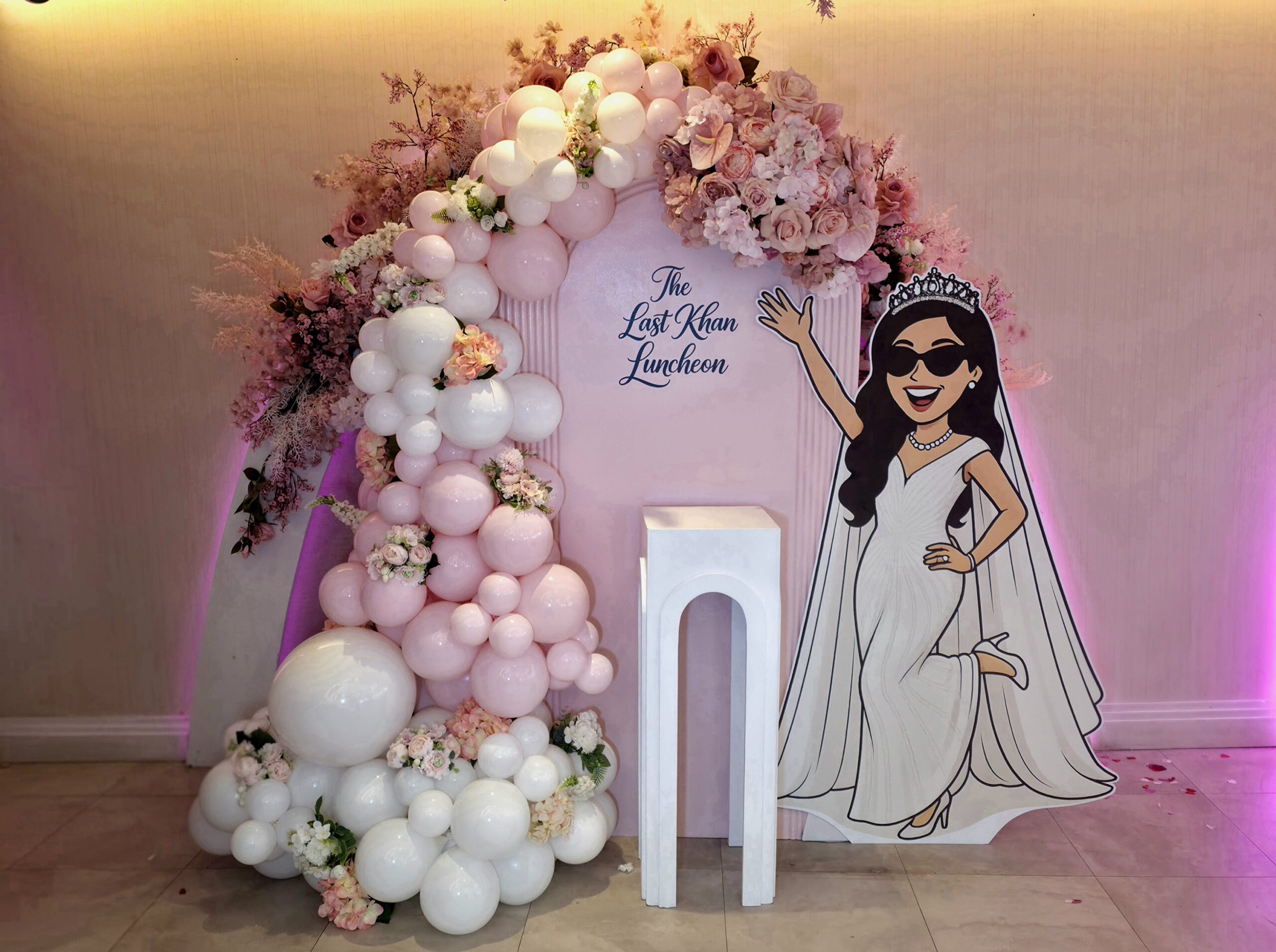 Pink and white bridal shower decor for The Last Khan Luncheon at Wattan Southall featuring a balloon arch, floral styling and personalised backdrop.